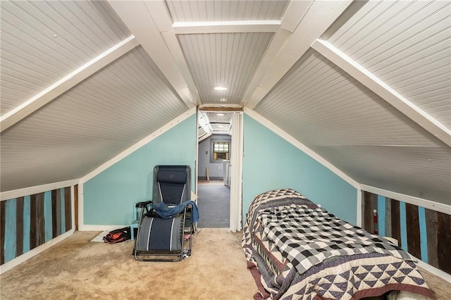 bedroom with carpet floors and vaulted ceiling