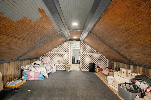 interior space with vaulted ceiling and wood walls