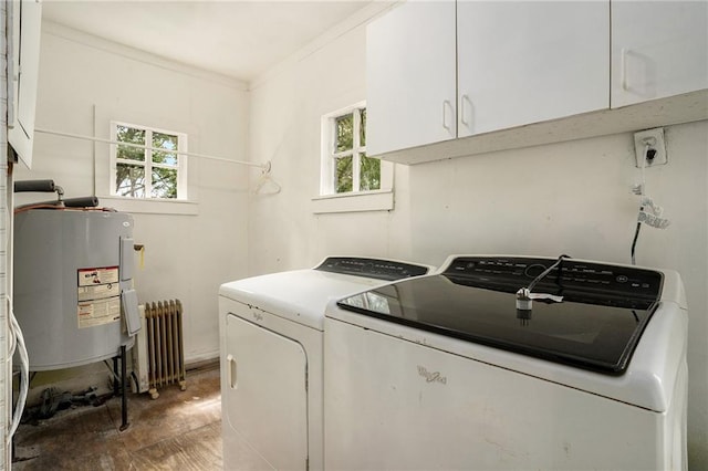 washroom with electric water heater, a healthy amount of sunlight, independent washer and dryer, radiator, and cabinets