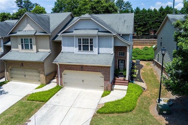 2968 Oshields Ct SW Unit 4, Marietta, GA 30060 - view of front facade featuring brick siding, an attached garage, and board and batten siding