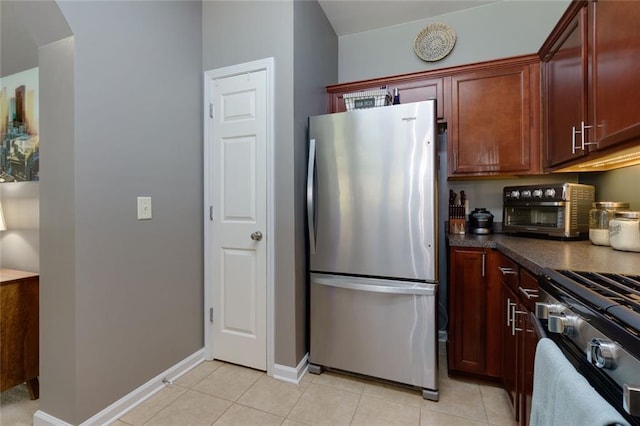 2968 Oshields Ct SW Unit 4, Marietta, GA 30060 - kitchen with stainless steel appliances, dark countertops, light tile patterned floors, and baseboards