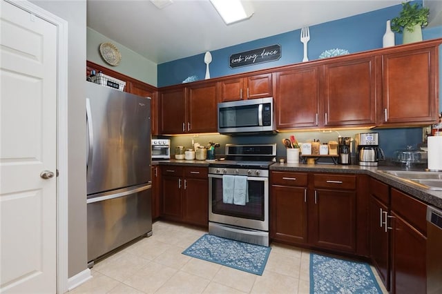 2968 Oshields Ct SW Unit 4, Marietta, GA 30060 - kitchen featuring stainless steel appliances, dark countertops, a sink, and light tile patterned floors