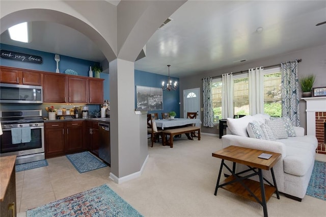 2968 Oshields Ct SW Unit 4, Marietta, GA 30060 - kitchen with appliances with stainless steel finishes, a chandelier, baseboards, light carpet, and open floor plan