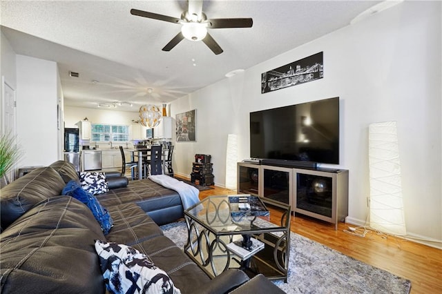 living room featuring hardwood / wood-style flooring and an inviting chandelier