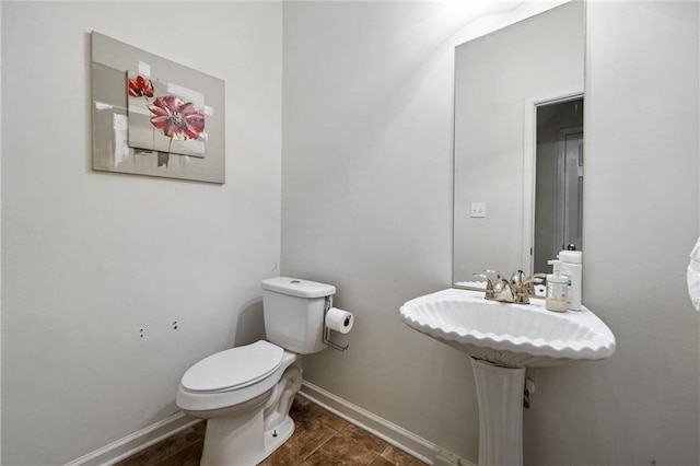 bathroom featuring tile patterned flooring and toilet