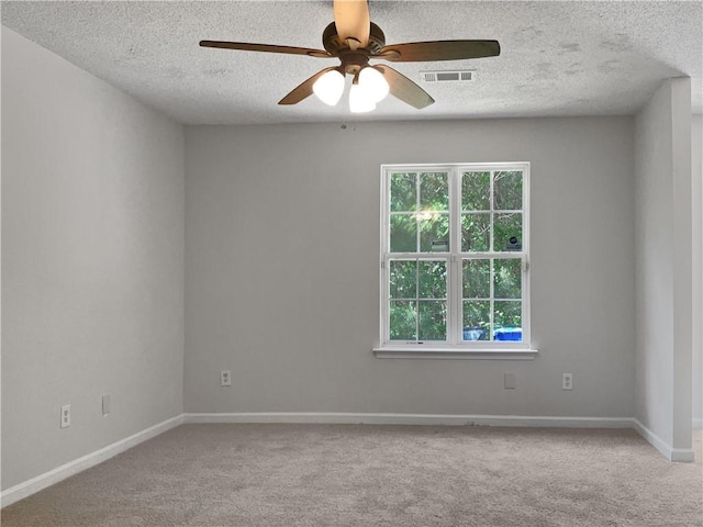 carpeted empty room featuring a textured ceiling and ceiling fan