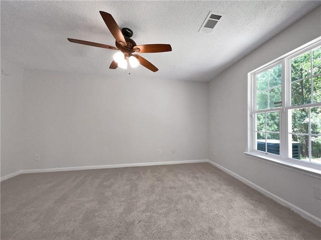 spare room with ceiling fan, carpet, and a textured ceiling