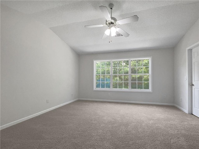 spare room featuring a textured ceiling, carpet floors, and ceiling fan