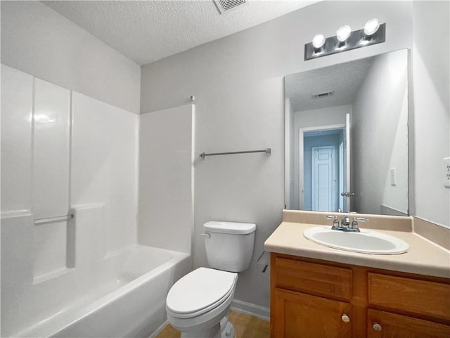 full bathroom with a textured ceiling, vanity, toilet, and tub / shower combination