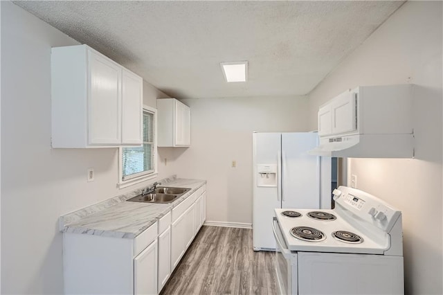 kitchen with sink, white appliances, white cabinetry, a textured ceiling, and light wood-type flooring