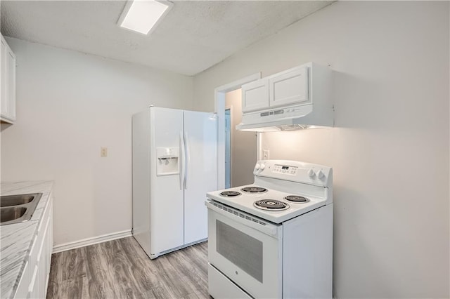 kitchen with white cabinetry, sink, white appliances, and light hardwood / wood-style flooring