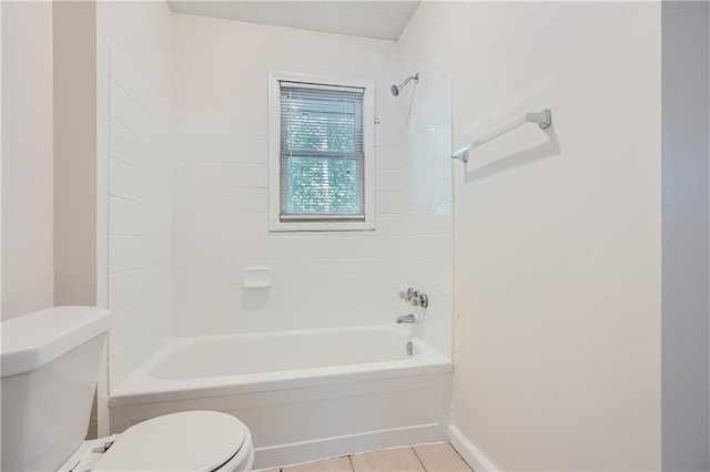 bathroom featuring tiled shower / bath combo, tile patterned floors, and toilet