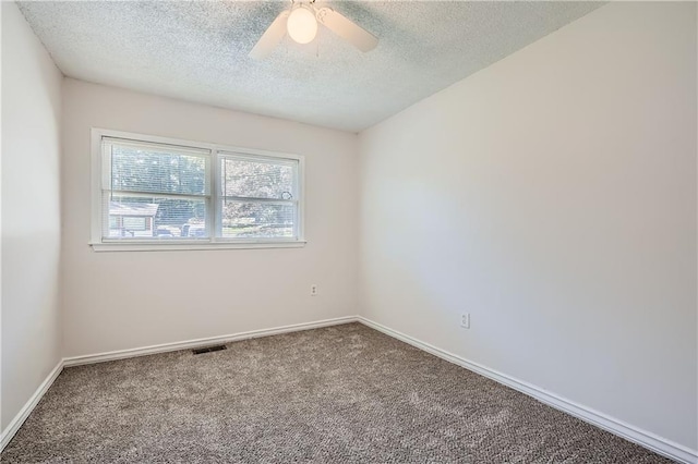 carpeted spare room with a textured ceiling and ceiling fan