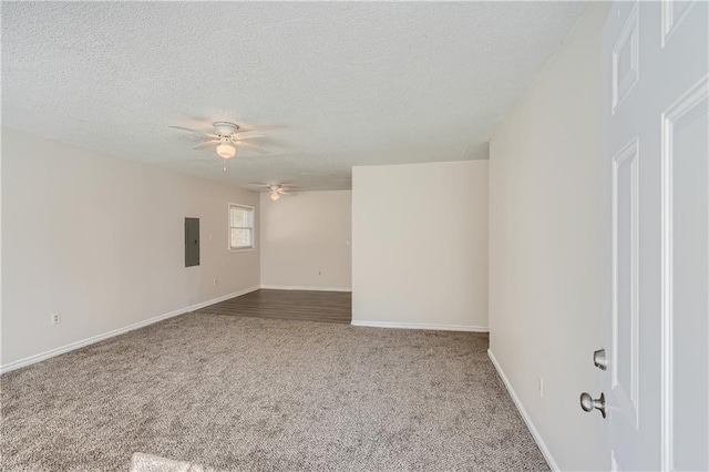 unfurnished room featuring ceiling fan, carpet flooring, electric panel, and a textured ceiling