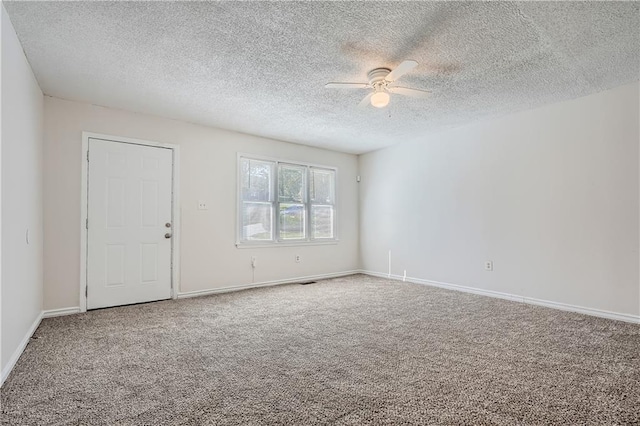 unfurnished room featuring carpet floors, a textured ceiling, and ceiling fan