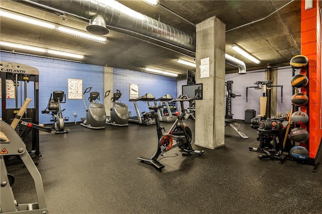 gym featuring concrete block wall