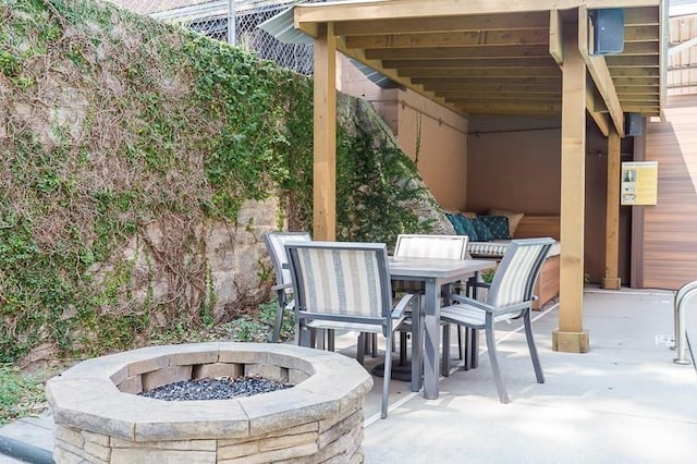 view of patio with outdoor dining space and a fire pit