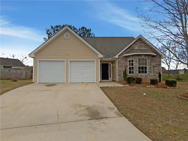 ranch-style home with concrete driveway, stone siding, and an attached garage