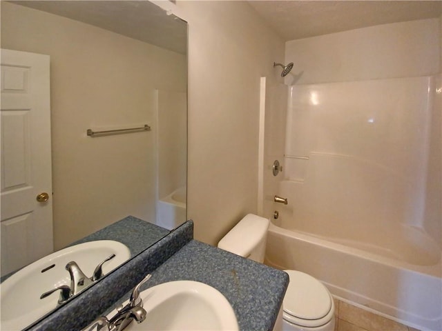 bathroom featuring toilet, tile patterned flooring, washtub / shower combination, and vanity