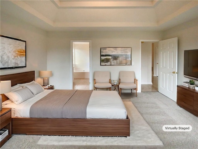 bedroom featuring ensuite bath, a raised ceiling, and light colored carpet