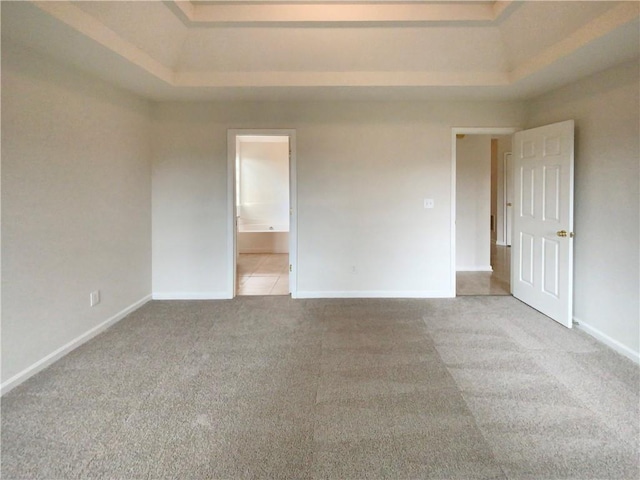 carpeted empty room featuring baseboards