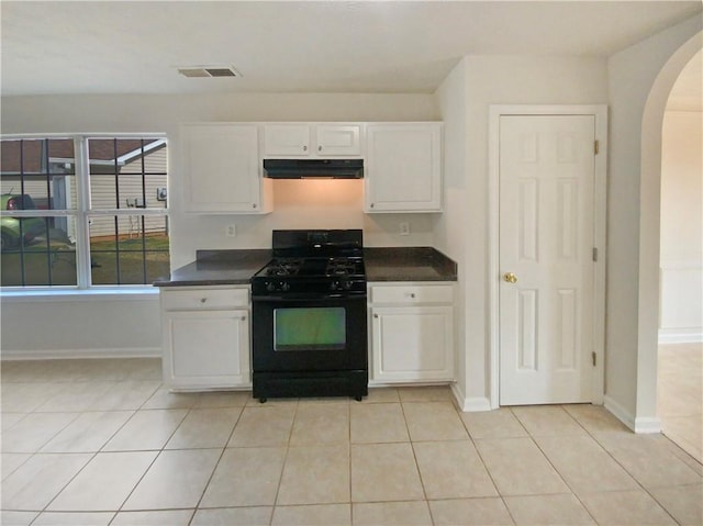 kitchen featuring visible vents, white cabinets, dark countertops, black gas stove, and under cabinet range hood