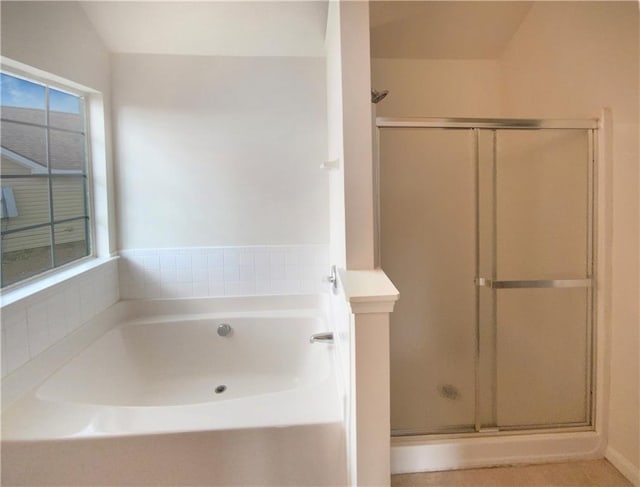 bathroom with a shower stall and a bath