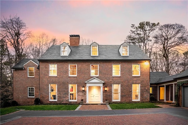 colonial home featuring a lawn