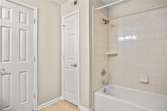 bathroom with tile patterned floors and tiled shower / bath