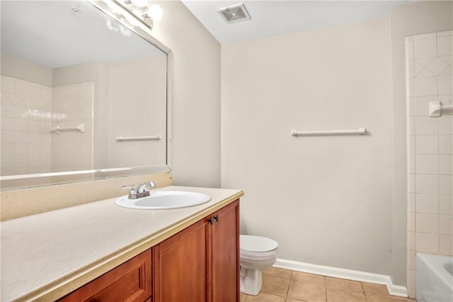 bathroom featuring tile patterned flooring, vanity, and toilet