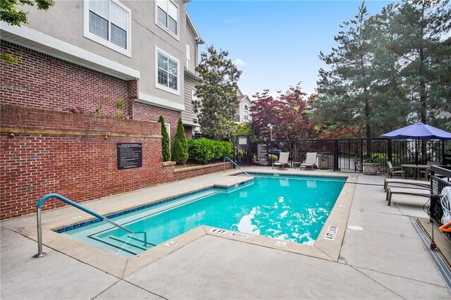 view of swimming pool with a patio