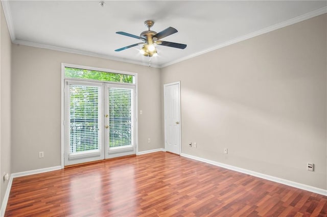 spare room with ceiling fan, wood-type flooring, ornamental molding, and french doors