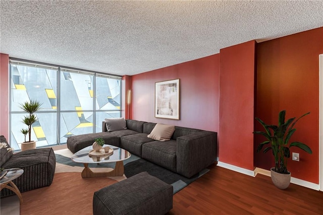 living room with a textured ceiling, dark hardwood / wood-style flooring, and a wealth of natural light