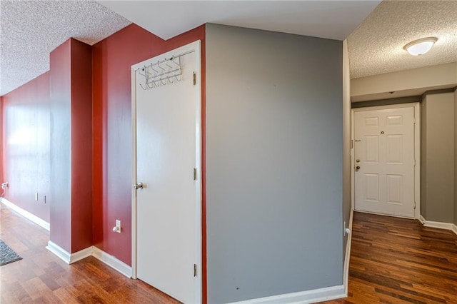 hall featuring dark hardwood / wood-style floors and a textured ceiling