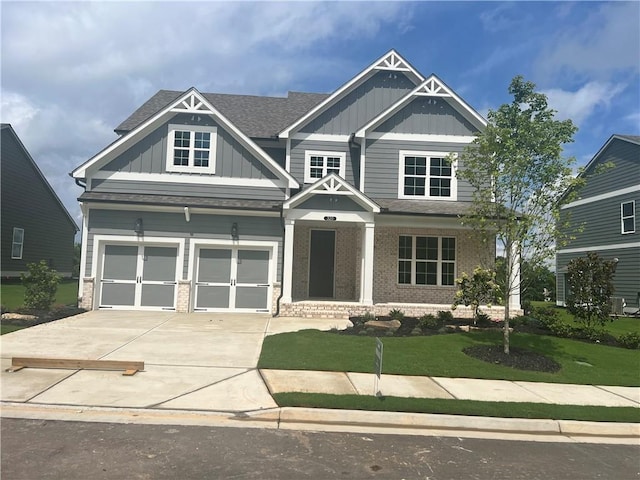 craftsman-style home featuring a garage and a front lawn