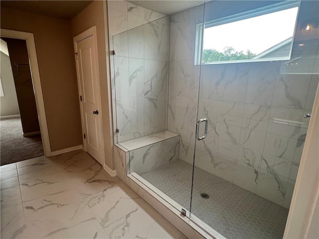 bathroom with a skylight and an enclosed shower