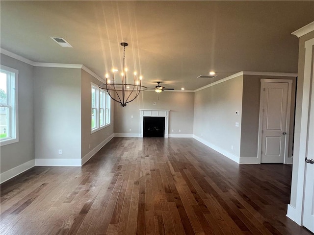 unfurnished living room featuring ceiling fan with notable chandelier, ornamental molding, and dark hardwood / wood-style flooring