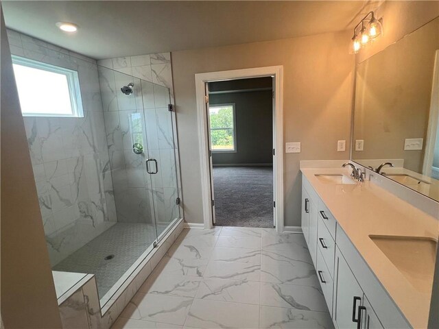 bathroom with a shower with door and vanity