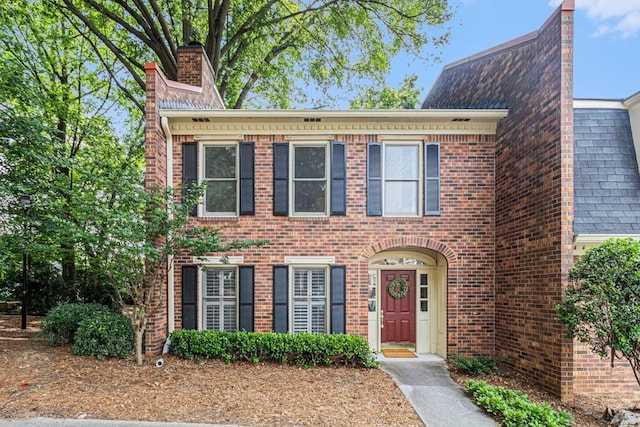 6 Stratford Hall Pl NE, Atlanta, GA 30342 - view of front facade with brick siding and a chimney