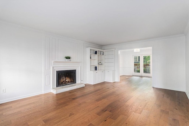 6 Stratford Hall Pl NE, Atlanta, GA 30342 - unfurnished living room with crown molding, a lit fireplace, wood finished floors, and baseboards