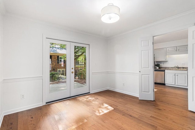 6 Stratford Hall Pl NE, Atlanta, GA 30342 - empty room with french doors, a sink, light wood-style floors, ornamental molding, and baseboards