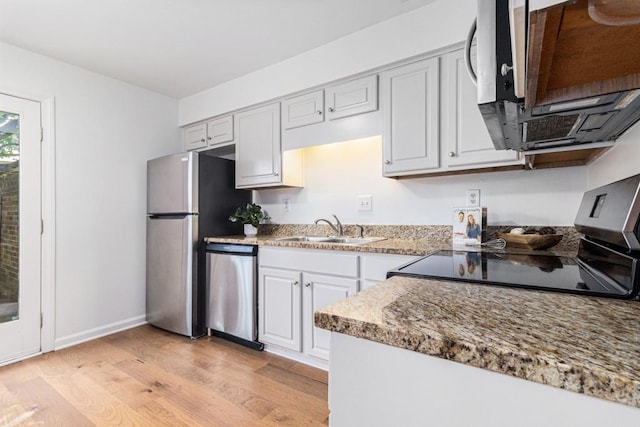 6 Stratford Hall Pl NE, Atlanta, GA 30342 - kitchen featuring a sink, appliances with stainless steel finishes, light wood-style floors, baseboards, and light countertops
