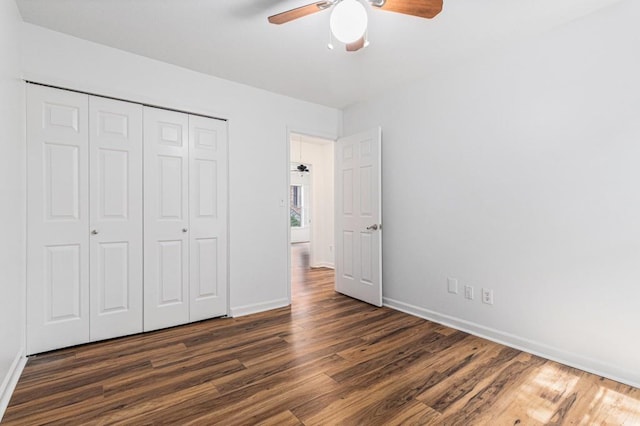 6 Stratford Hall Pl NE, Atlanta, GA 30342 - unfurnished bedroom featuring dark wood-type flooring, baseboards, a closet, and a ceiling fan