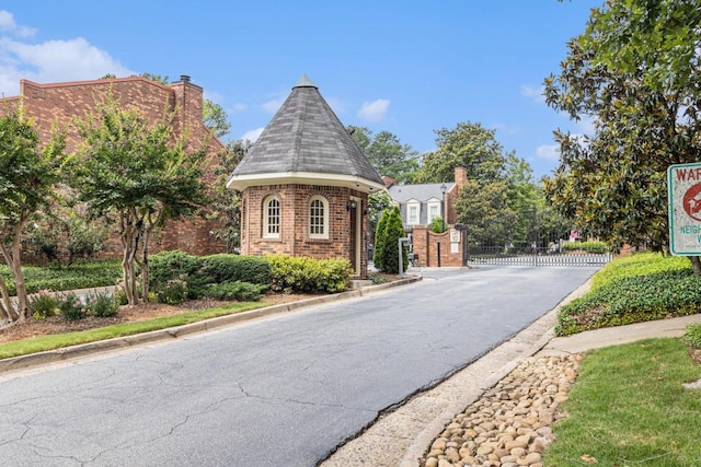 6 Stratford Hall Pl NE, Atlanta, GA 30342 - view of asphalt road with a gate, curbs, and a gated entry