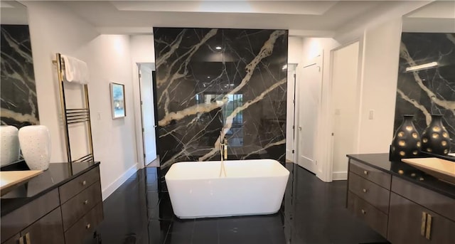 6711 Bishop Rd, Fairburn, GA 30213 - bathroom featuring vanity, a freestanding bath, tile walls, and a towel warming rack