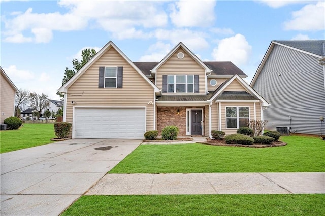 view of front of home with a front lawn, concrete driveway, central AC, and an attached garage