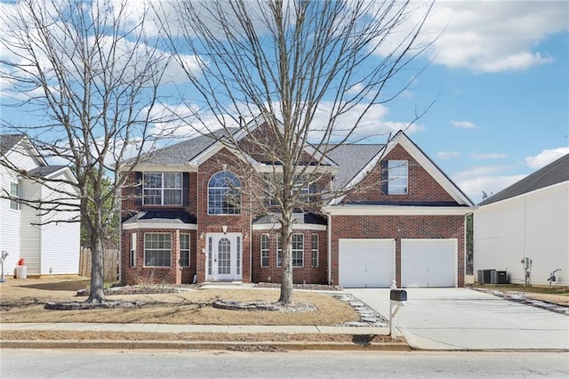 view of front facade featuring a garage, central AC unit, concrete driveway, and brick siding