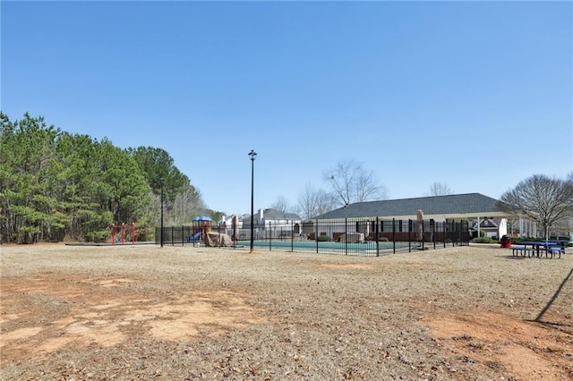 view of community with fence and playground community