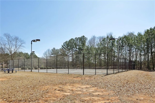 view of tennis court with fence