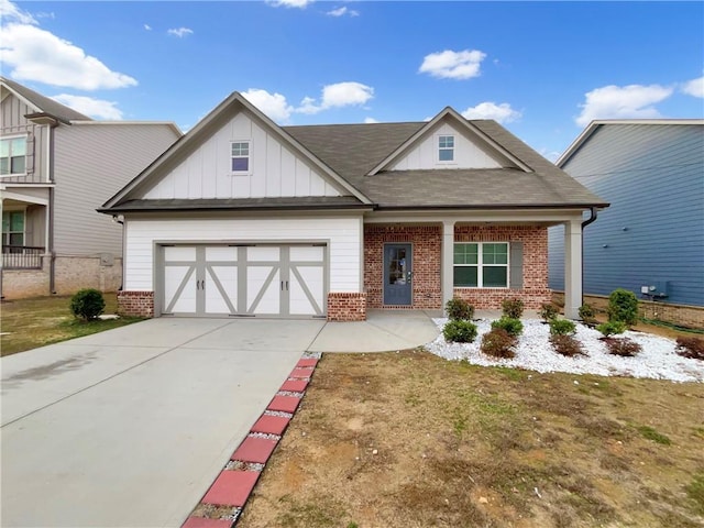 view of front of house featuring a garage, concrete driveway, brick siding, and board and batten siding